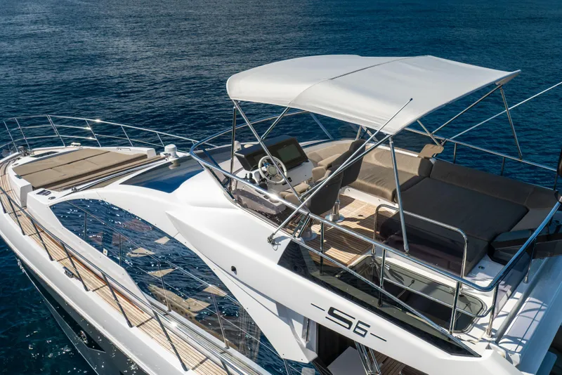 Slide: The Image of 2021 Azimut S6 Sportfly yacht cruising on open sea, featuring luxurious deck and seating. - 40