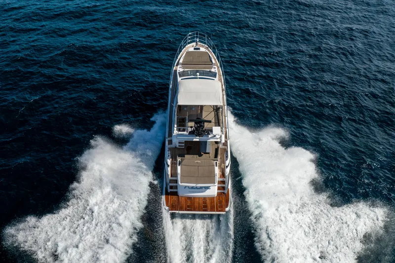Slide: The Image of 2021 Azimut S6 Sportfly yacht cruising on open sea, rear view. - 47