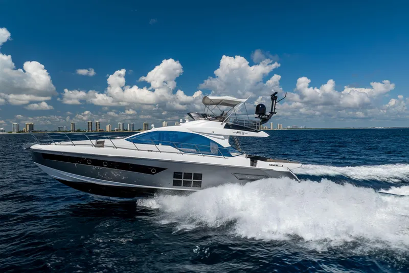 Slide: The Image of 2021 Azimut S6 Sportfly yacht cruising on open water under a clear blue sky. - 5