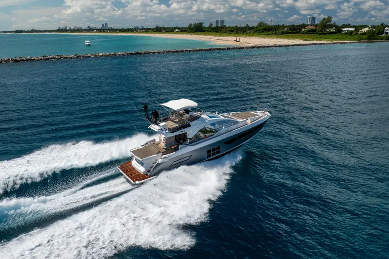 Slide: The Image of 2021 Azimut S6 Sportfly yacht cruising near a scenic coastline. - 9