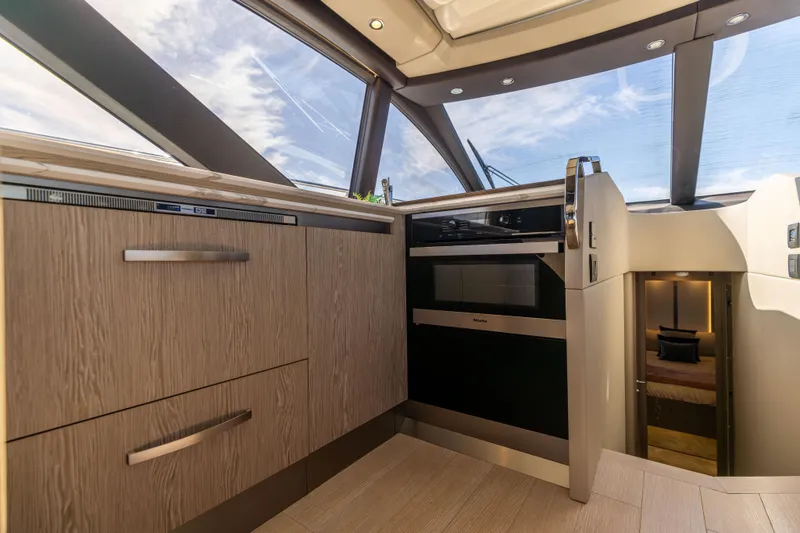 Slide: The Image of Modern kitchen interior of 2021 Azimut S6 Sportfly yacht with wood cabinetry and sleek appliances. - 94