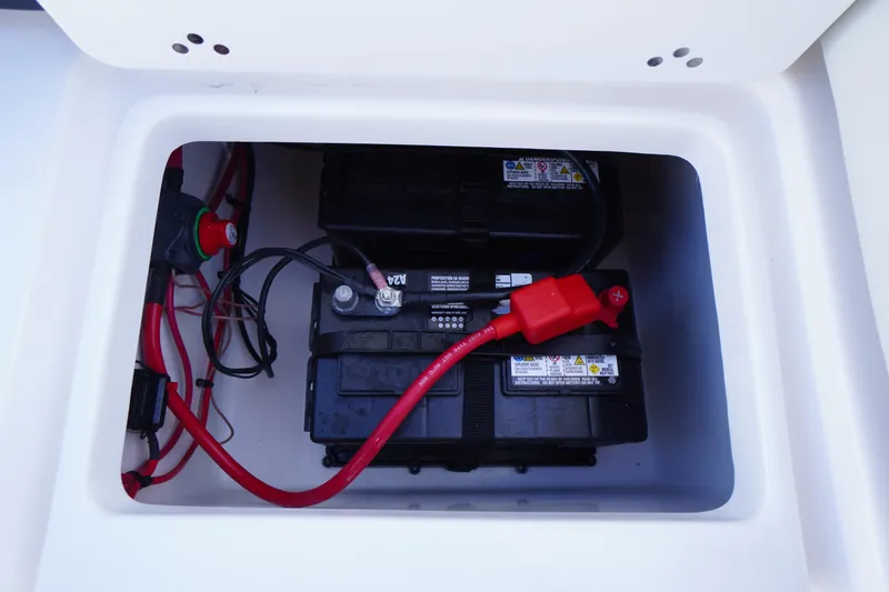 Slide: The Image of Battery compartment of 2024 Tidewater 232 SS boat with wiring and connections. - 11