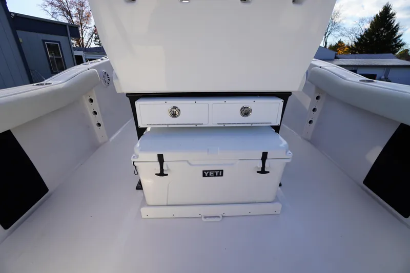 Slide: The Image of 2024 Tidewater 232 SS boat interior with Yeti cooler and storage drawers. - 15