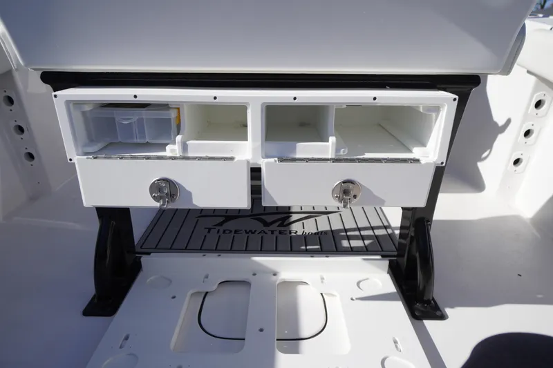 Slide: The Image of 2024 Tidewater 232 SS boat storage compartments with secure locks and organized layout. - 16
