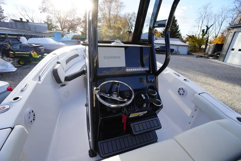 Slide: The Image of 2024 Tidewater 232 SS boat interior with Garmin navigation system and steering console. - 18