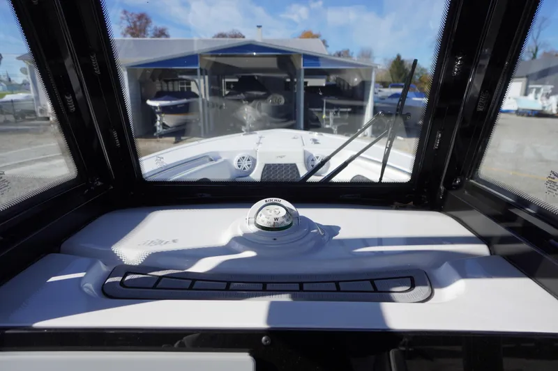 Slide: The Image of 2024 Tidewater 232 SS boat interior view with compass and windshield. - 20