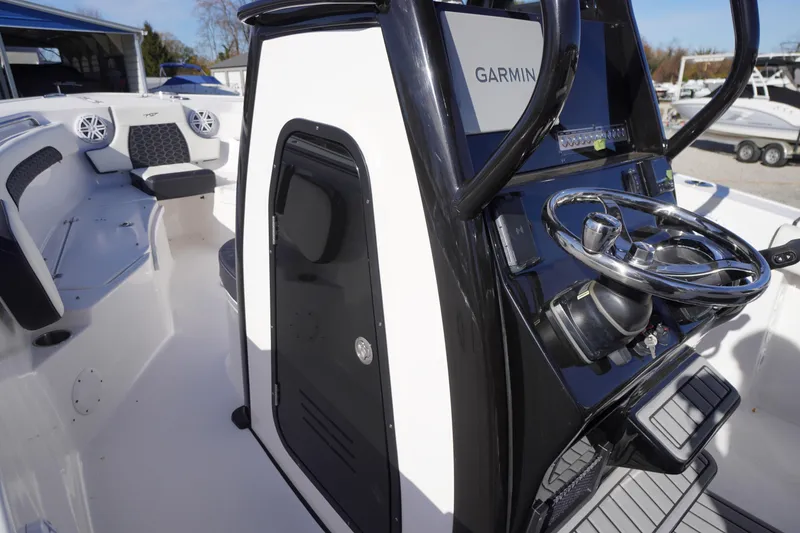 Slide: The Image of 2024 Tidewater 232 SS boat interior with Garmin navigation and sleek steering console. - 24