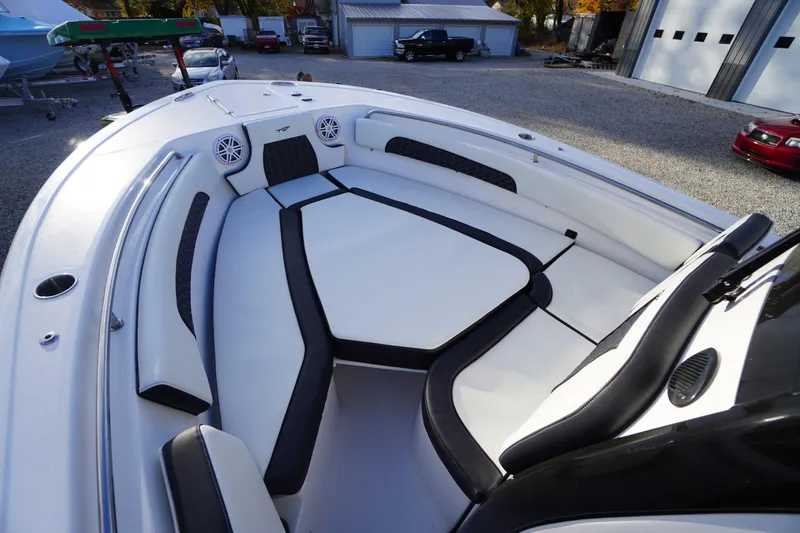 Slide: The Image of 2024 Tidewater 232 SS boat interior with cushioned seating and speakers. - 25