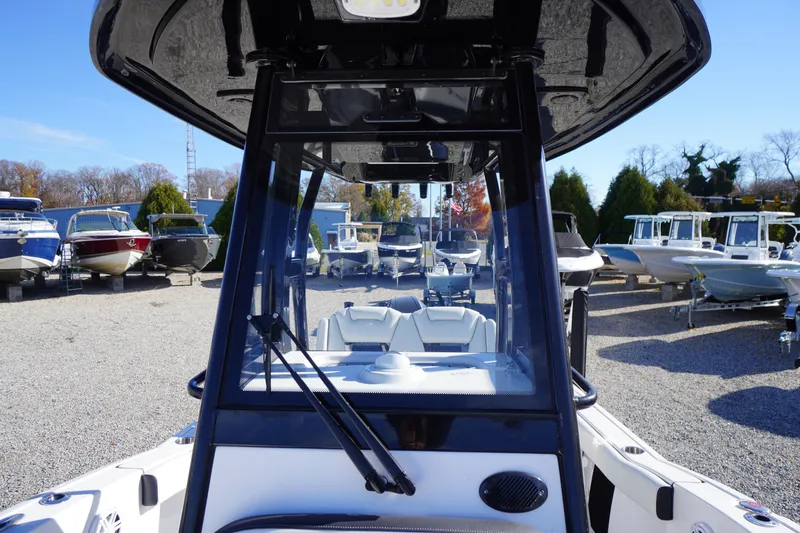 Slide: The Image of 2024 Tidewater 232 SS boat displayed in a marina with other boats. - 28