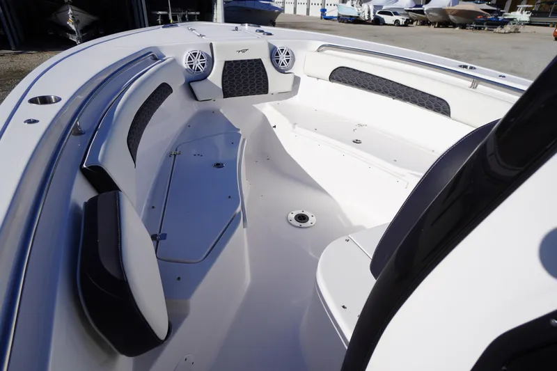 Slide: The Image of 2024 Tidewater 232 SS boat interior with seating and speakers. - 29