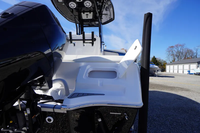 Slide: The Image of 2024 Tidewater 232 SS boat with sleek design and powerful engine, docked outdoors. - 3