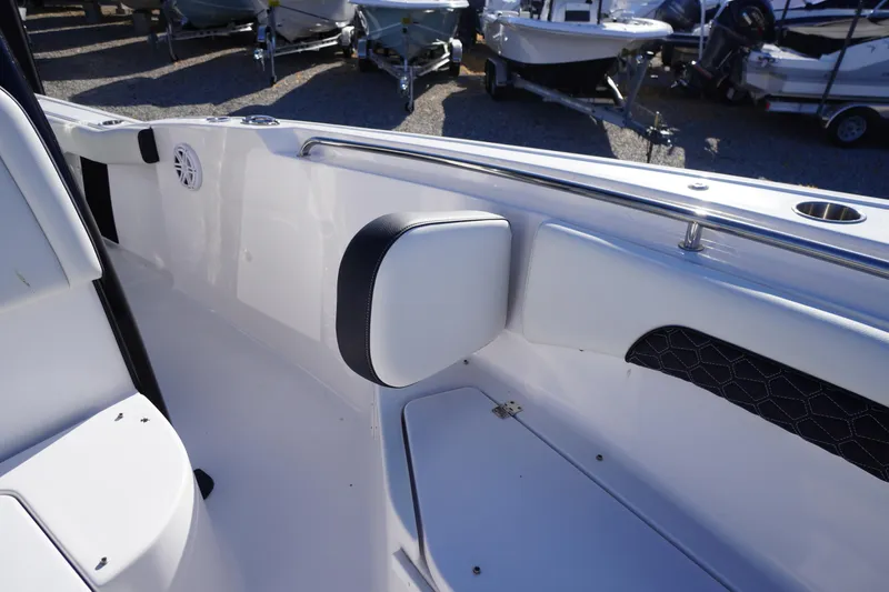 Slide: The Image of 2024 Tidewater 232 SS boat interior with cushioned seating and stainless steel railings. - 33