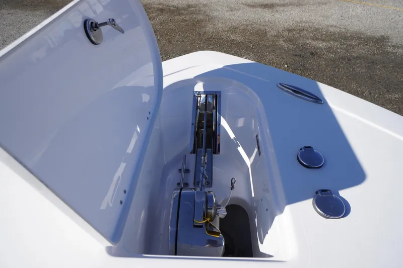 Slide: The Image of 2024 Tidewater 232 SS boat anchor compartment with open hatch, showcasing storage features. - 34