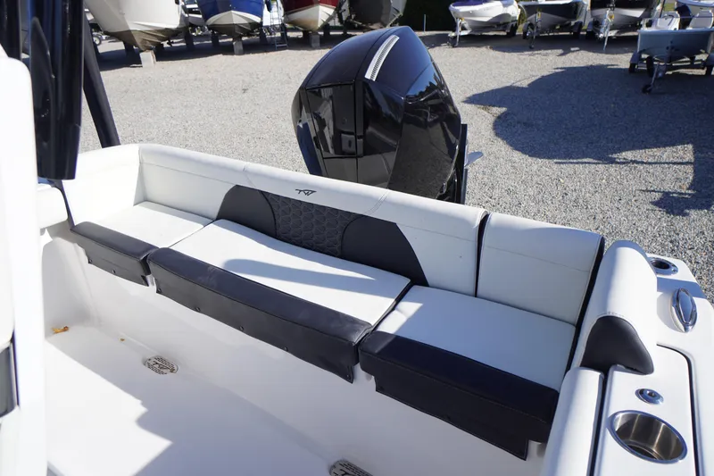 Slide: The Image of 2024 Tidewater 232 SS boat interior with cushioned seating and sleek design. - 36