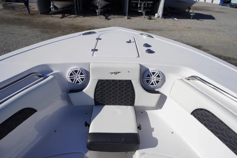 Slide: The Image of 2024 Tidewater 232 SS boat interior with cushioned seating and speakers. - 38