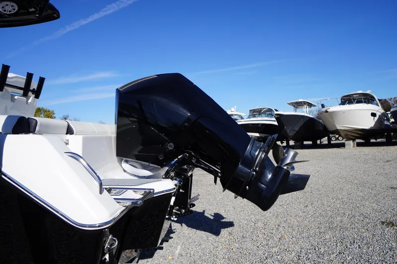 Slide: The Image of 2024 Tidewater 232 SS boat with powerful outboard motor, displayed on gravel lot under clear blue sky. - 4