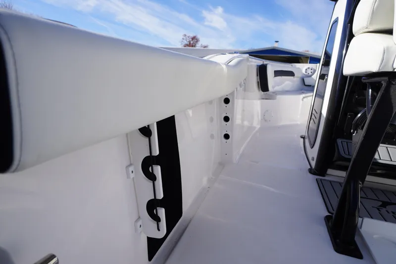 Slide: The Image of 2024 Tidewater 232 SS boat interior with white seating and sleek design. - 42