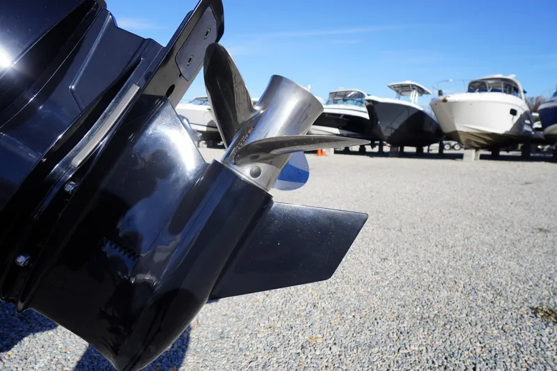 Slide: The Image of 2024 Tidewater 232 SS boat propeller with other boats in the background on gravel. - 44