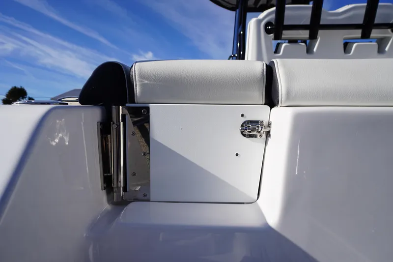 Slide: The Image of 2024 Tidewater 232 SS boat seat detail with latch, under clear blue sky. - 5