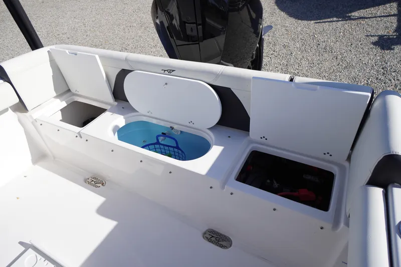 Slide: The Image of 2024 Tidewater 232 SS boat interior with storage compartments and livewell. - 8
