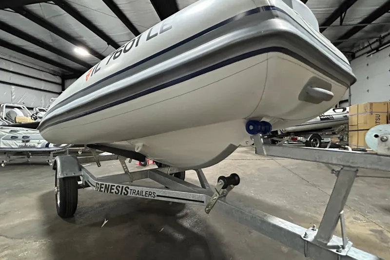 Slide: The Image of 2023 Highfield Classic 310 boat on Genesis trailer in indoor storage facility. - 14