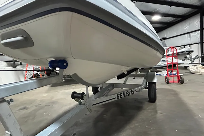 Slide: The Image of 2023 Highfield Classic 310 boat on Genesis trailer in warehouse setting. - 15