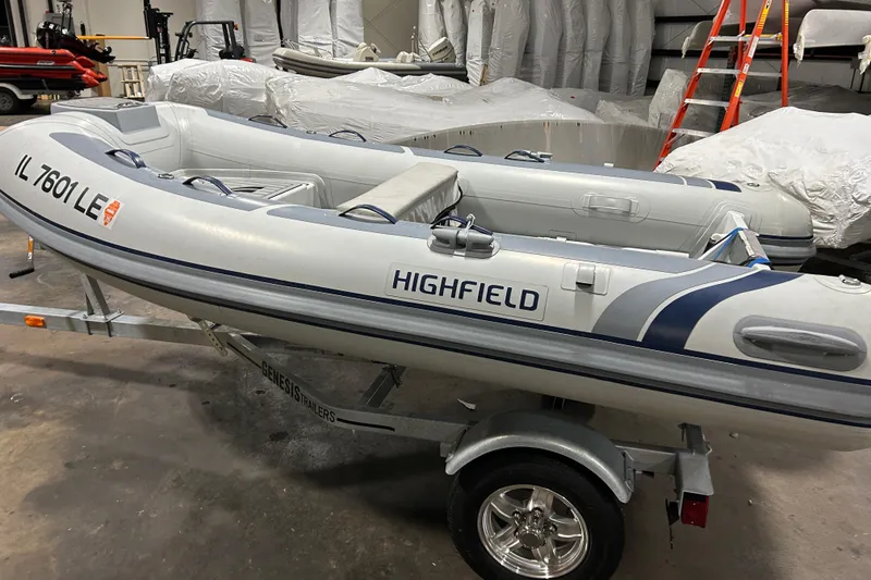 Slide: The Image of 2023 Highfield Classic 310 inflatable boat on trailer in a storage facility. - 5