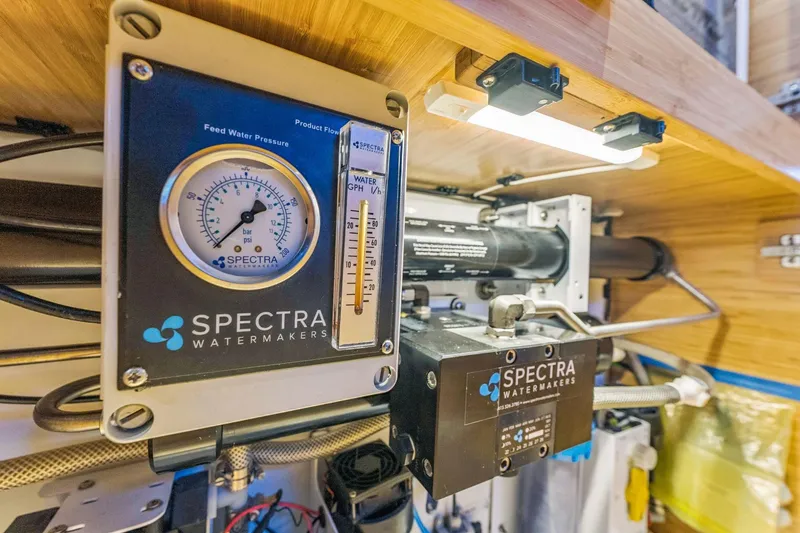Slide: The Image of Spectra Watermakers system in Balance 482, 2024 model, showing pressure gauge and flow meter. - 102