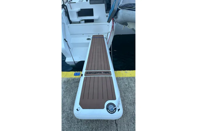 Slide: The Image of Balance 482 boat with brown deck, docked at marina, 2023 model. - 118