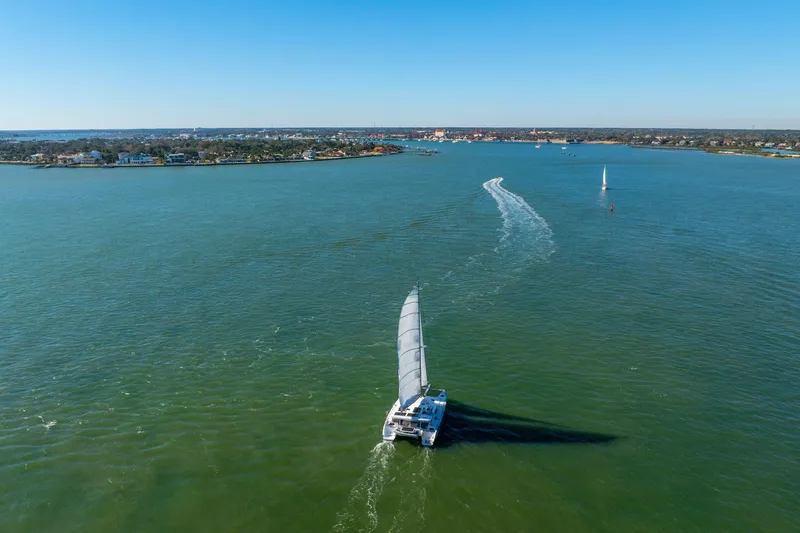 Slide: The Image of Sailboat Balance 482 cruising on open water, 2024 model, under clear blue skies. - 122