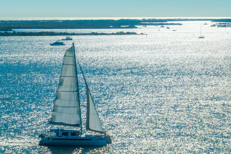 Slide: The Image of Sailboat Balance 482 gliding on sparkling water, 2024 model, under clear blue sky. - 123