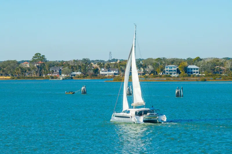 Slide: The Image of Sailboat Balance 482 cruising on a serene blue lake, 2024 model. - 125