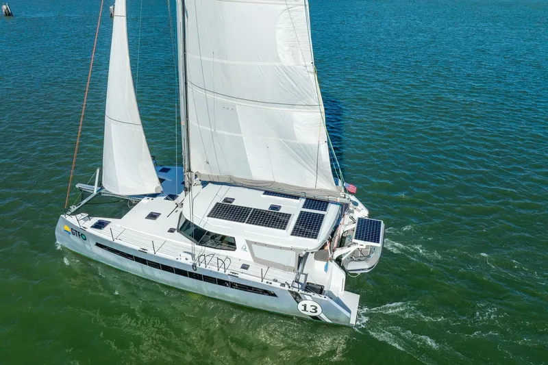 Slide: The Image of Sailing catamaran Balance 482, 2024 model, with solar panels on open water. - 126