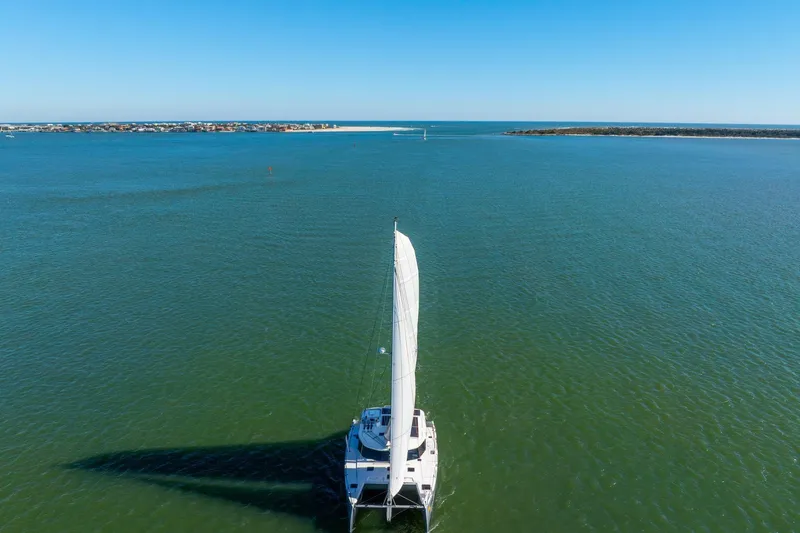 Slide: The Image of Sailing catamaran Balance 482, 2024 model, cruising on open sea under clear blue sky. - 127