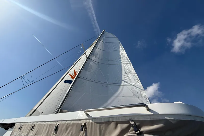 Slide: The Image of Sailboat Balance 482, 2023 model, with sails against a clear blue sky. - 131