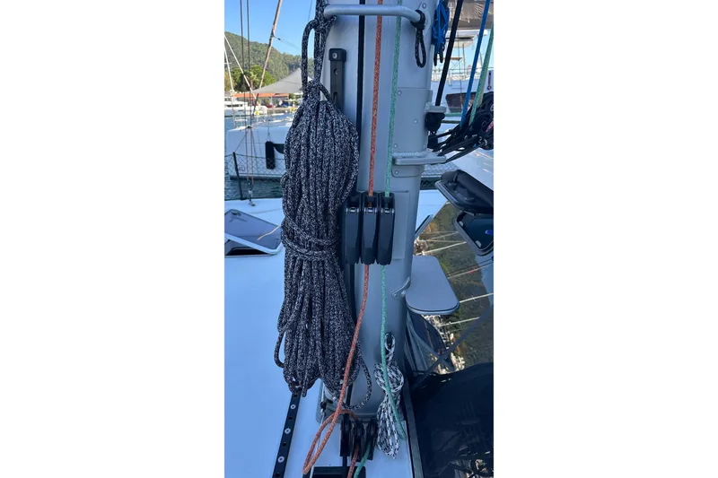 Slide: The Image of Sailboat with solar panel on deck, Balance 482 model, 2024, near waterfront homes. - 28