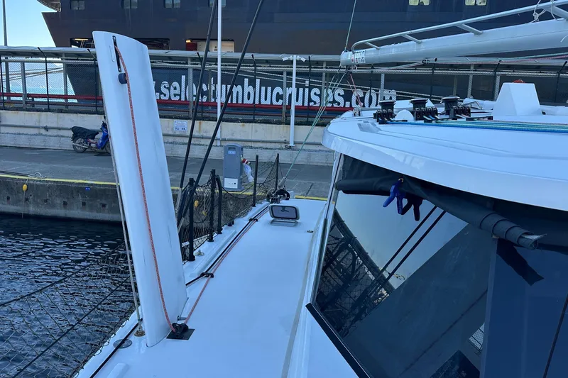 Slide: The Image of Sailboat Balance 482 cruising on blue water near a scenic shoreline, 2024 model. - 5