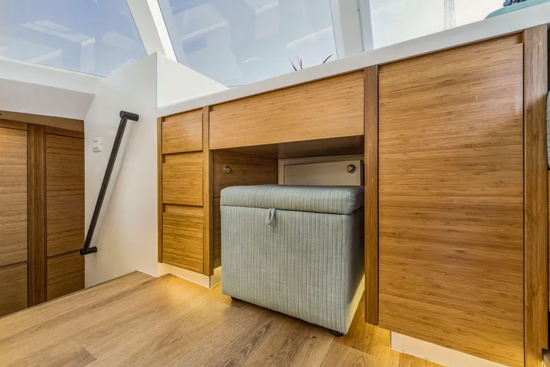 Slide: The Image of Modern interior with wooden cabinets and a cushioned ottoman, Balance 482, 2024 model. - 87