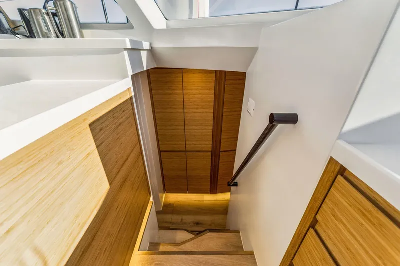 Slide: The Image of Modern interior staircase on Balance 482 yacht, 2024 model, featuring sleek wood and white design. - 88