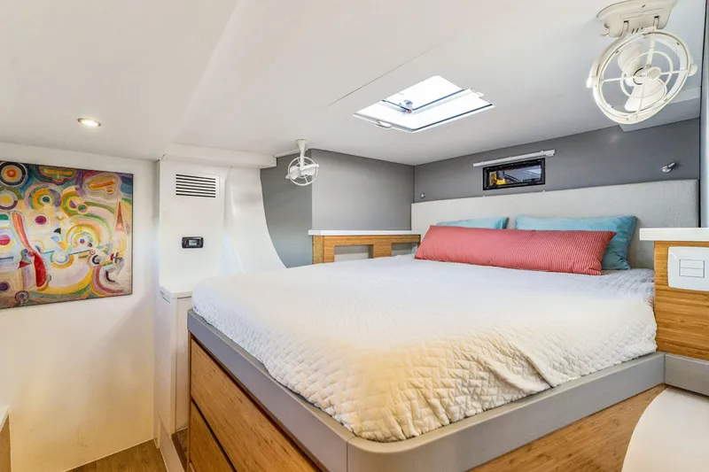Slide: The Image of Modern bedroom interior in 2024 Balance 482 yacht, featuring colorful artwork and skylight. - 95