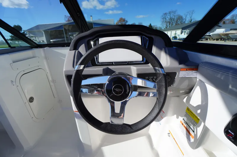 Slide: The Image of 2026 Chaparral 23 SSi boat steering wheel and dashboard, showcasing modern design. - 20