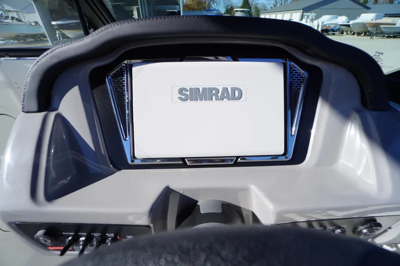 Slide: The Image of Dashboard of 2026 Chaparral 23 SSi boat featuring Simrad display. - 21