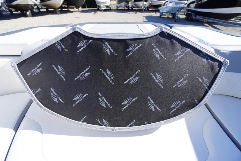 Slide: The Image of 2026 Chaparral 23 SSi boat interior with branded cover, showcasing luxury design. - 31