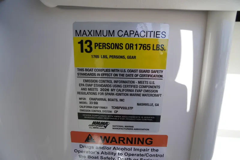 Slide: The Image of 2026 Chaparral 23 SSi boat capacity label, 13 persons or 1765 lbs, safety compliance. - 32