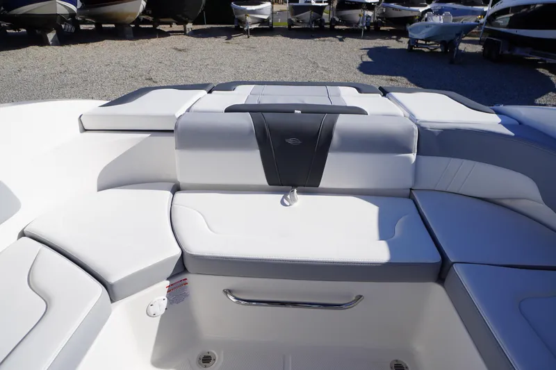Slide: The Image of 2026 Chaparral 23 SSi boat interior with white seating and storage compartment. - 37