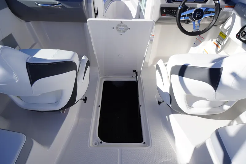 Slide: The Image of 2026 Chaparral 23 SSi boat interior with white seating and storage compartment. - 45