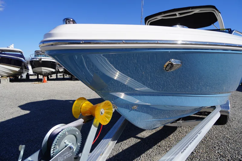 Slide: The Image of 2026 Chaparral 23 SSi boat on trailer, blue hull, sunny day, outdoor display. - 68