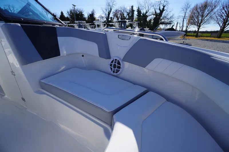 Slide: The Image of 2026 Chaparral 23 SSi boat interior with cushioned seating and speaker. - 7