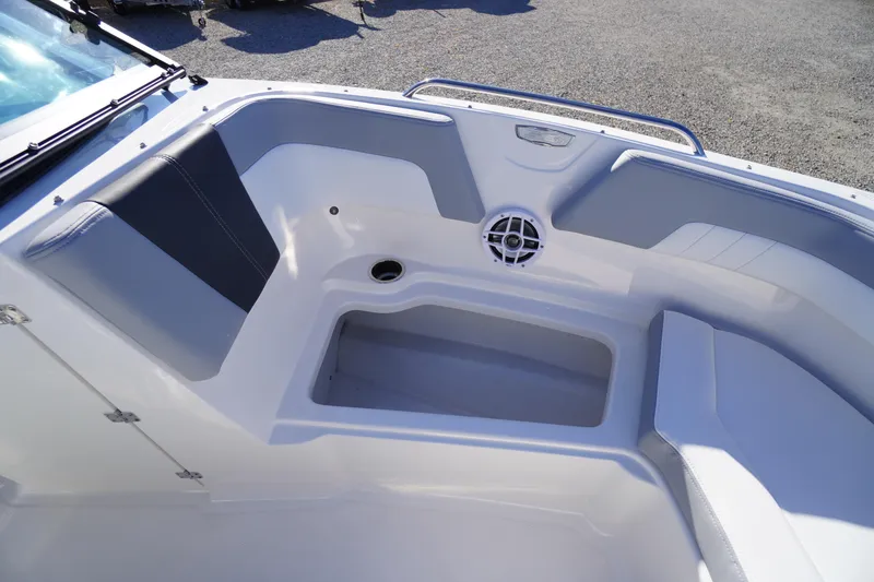 Slide: The Image of Interior view of 2026 Chaparral 23 SSi boat, featuring seating and speaker. - 11