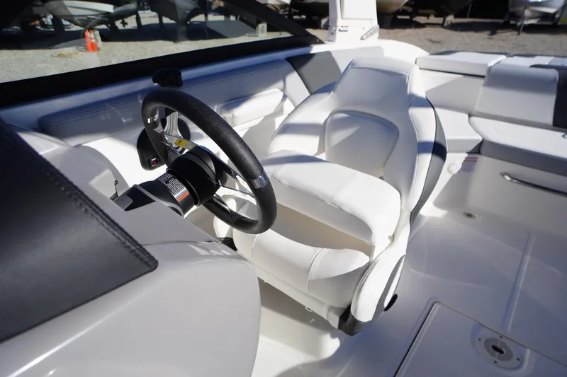 Slide: The Image of 2026 Chaparral 23 SSi boat interior with white seating and steering wheel. - 19